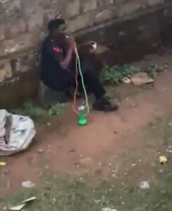 Captured image from viral video showing a man seemingly wearing a Nigeria Police Uniform vapping "Shisa" 